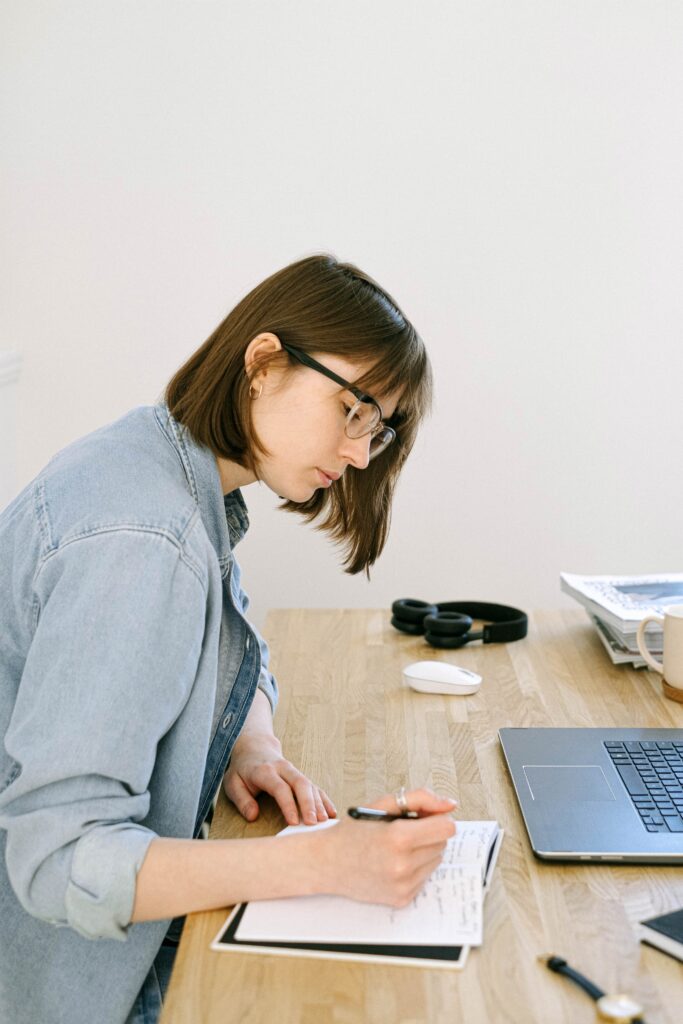 Woman Writing on a Notebook.